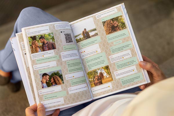 Woman reading from a zapptales hardcover WhatsApp chat book